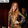 Actress Lindsay Lohan wears 'M' inital rings as she blows kisses to the camera at fashion party.